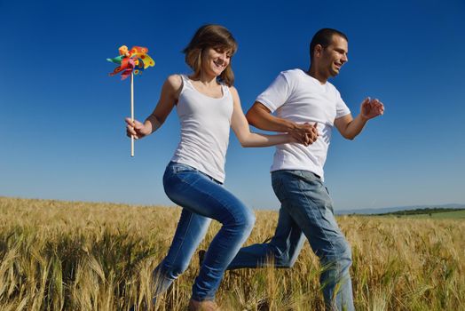 happy young couple in love have romance and fun at wheat field in summer