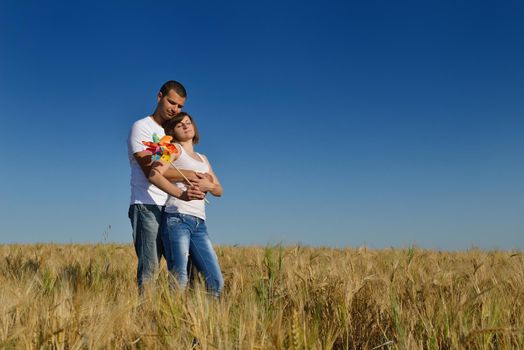 happy young couple in love have romance and fun at wheat field in summer