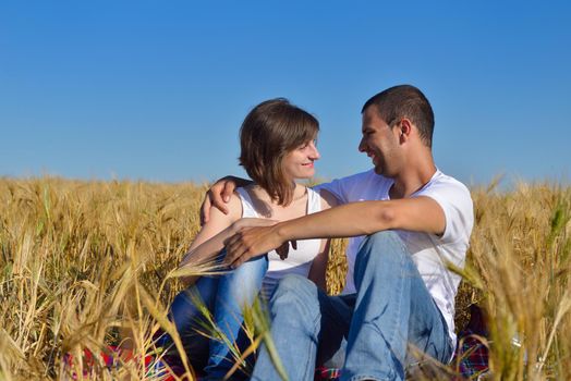 happy young couple in love have romance and fun at wheat field in summer