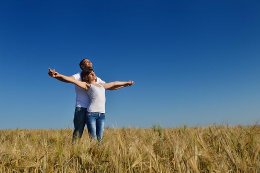 happy young couple in love have romance and fun at wheat field in summer