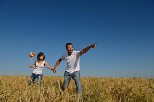 happy young couple in love have romance and fun at wheat field in summer