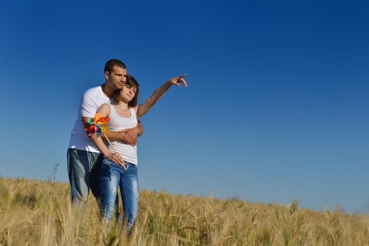 happy young couple in love have romance and fun at wheat field in summer