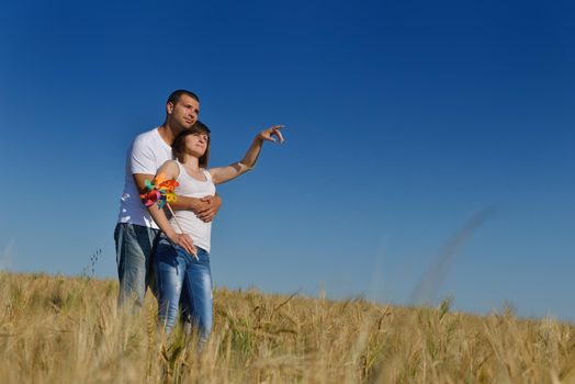 happy young couple in love have romance and fun at wheat field in summer