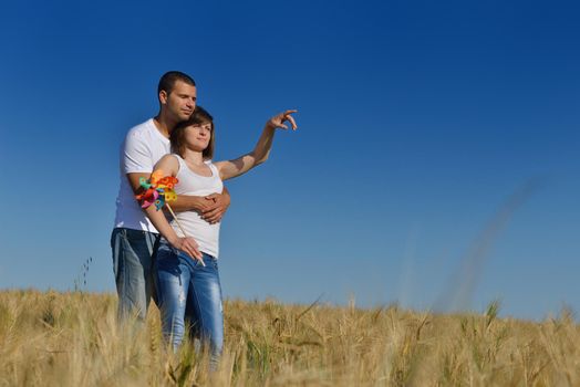 happy young couple in love have romance and fun at wheat field in summer