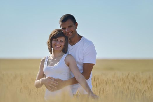 happy young couple in love have romance and fun at wheat field in summer