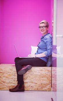 young woman in crative box working on laptop computer, startup business modern office room  interior