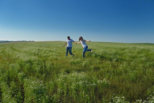 happy young couple in love have romance and fun at wheat field in summer