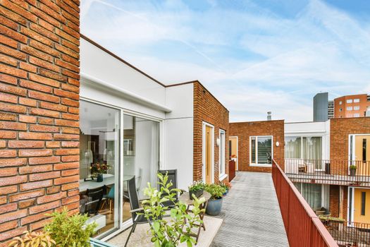 Stylish balcony with flowers connecting all apartments