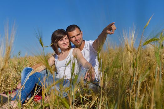 happy young couple in love have romance and fun at wheat field in summer