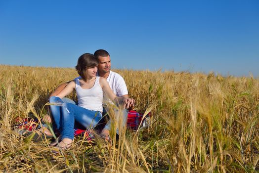 happy young couple in love have romance and fun at wheat field in summer