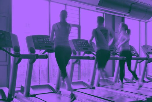 group of young people running on treadmills in modern sport  gym duo tone