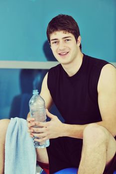 young man drink water at fitness workout training at sport club