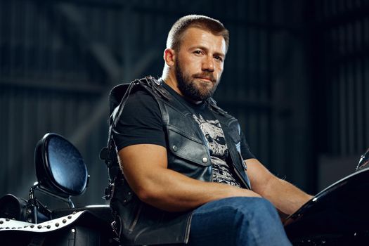 Portrait of motorbike rider in black leather outfit. Biker subculture
