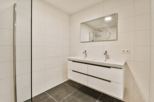 Delightful bathroom with large mirror and long sink