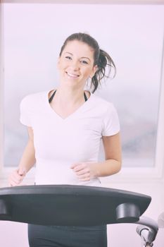 young woman exercise fitness and workout while run on track in sport club