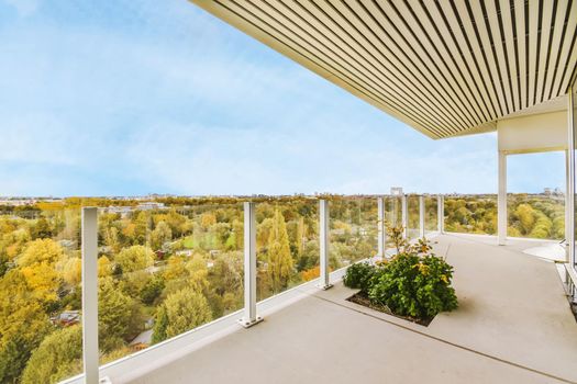 Enchanting balcony of a multi-storey building with glass railings