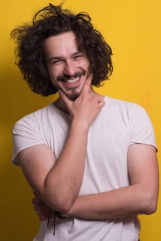 Portrait of a beautiful  young man with funny hair over color background with copyspace expressing different emotions