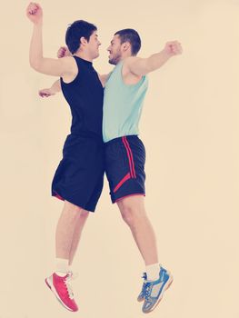 two young adults exercise fitness jumping and relaxing at sport gym club