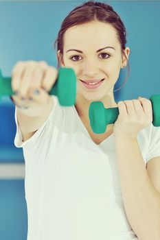 beaudiful young woman fitness workout with weights at sport club