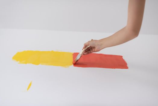 happy smiling young couple painting interior wall of new house