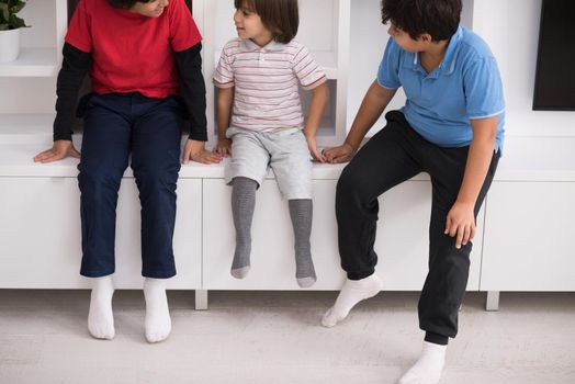 happy young boys are having fun while posing on a shelf in a new modern home