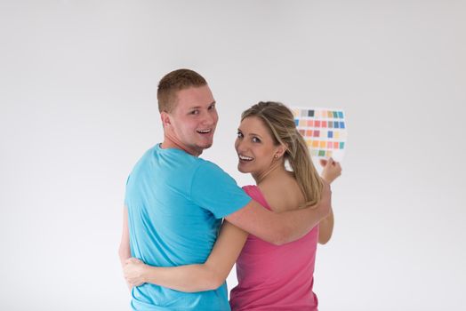 repair, interior design, building, renovation and home concept smiling couple looking at color samples at home