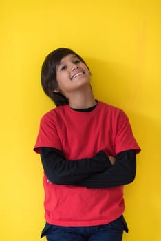 Portrait of a happy young boy in front of colored background