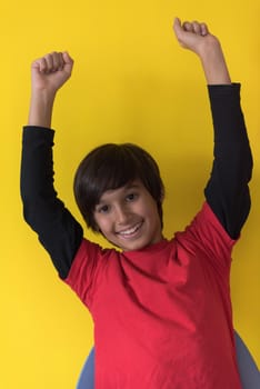 Portrait of a happy young boy in front of colored background