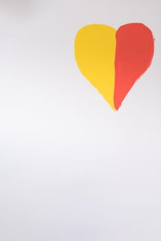 red and yellow heart on a white wall