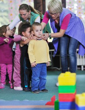 happy child kids group have fun and play at kindergarden indoor preschool education concept with  teacher