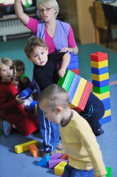 happy child kids group have fun and play at kindergarden indoor preschool education concept with  teacher