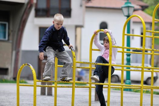 happy family sister and brother have fun and play games outdoor in park