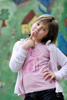 happy young girl posing and jumping with abstract urban style painting bacground begind