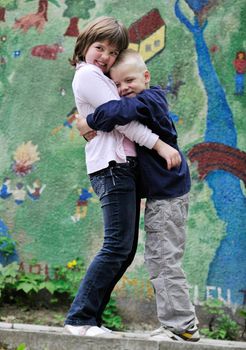 happy family sister and brother have fun and play games outdoor in park