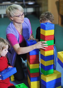 happy child kids group have fun and play at kindergarden indoor preschool education concept with  teacher