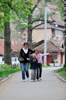 happy young family walking outdoor in park 