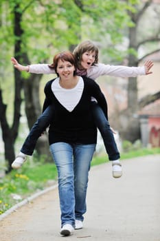 happy oung mother and daughter have fun outdoor 