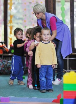 happy child kids group have fun and play at kindergarden indoor preschool education concept with  teacher