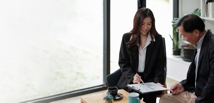 Senior asian man meeting financial adviser for investment, Financial advisor talks with client for financial planning after retirement.