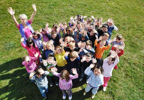 happy child kids group have fun and play at kindergarden outdoor preschool education concept with  teacher