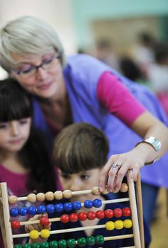 happy child kids group have fun and play at kindergarden indoor preschool education concept with  teacher