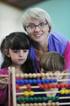 happy child kids group have fun and play at kindergarden indoor preschool education concept with  teacher