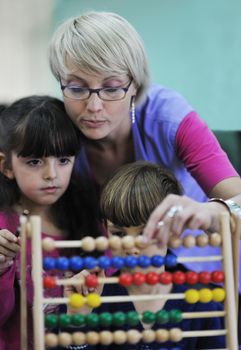 happy child kids group have fun and play at kindergarden indoor preschool education concept with  teacher