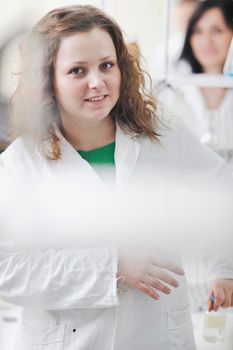 young woman students group in bright chemistry  lab