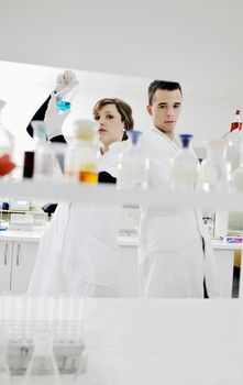 young students couple making test in bright labaratory