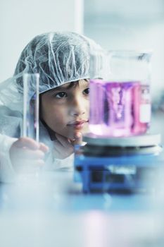 cute little male child have experiment with test tubes in bright modern lab