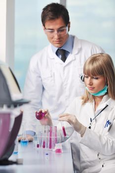 science and research biology chemistry an dmedicine  youn people couple in bright modern  lab