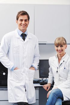 science and research biology chemistry an dmedicine  youn people couple in bright modern  lab