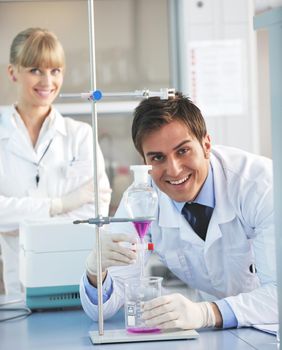 science and research biology chemistry an dmedicine  youn people couple in bright modern  lab