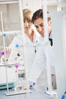 science and research biology chemistry an dmedicine  youn people couple in bright modern  lab